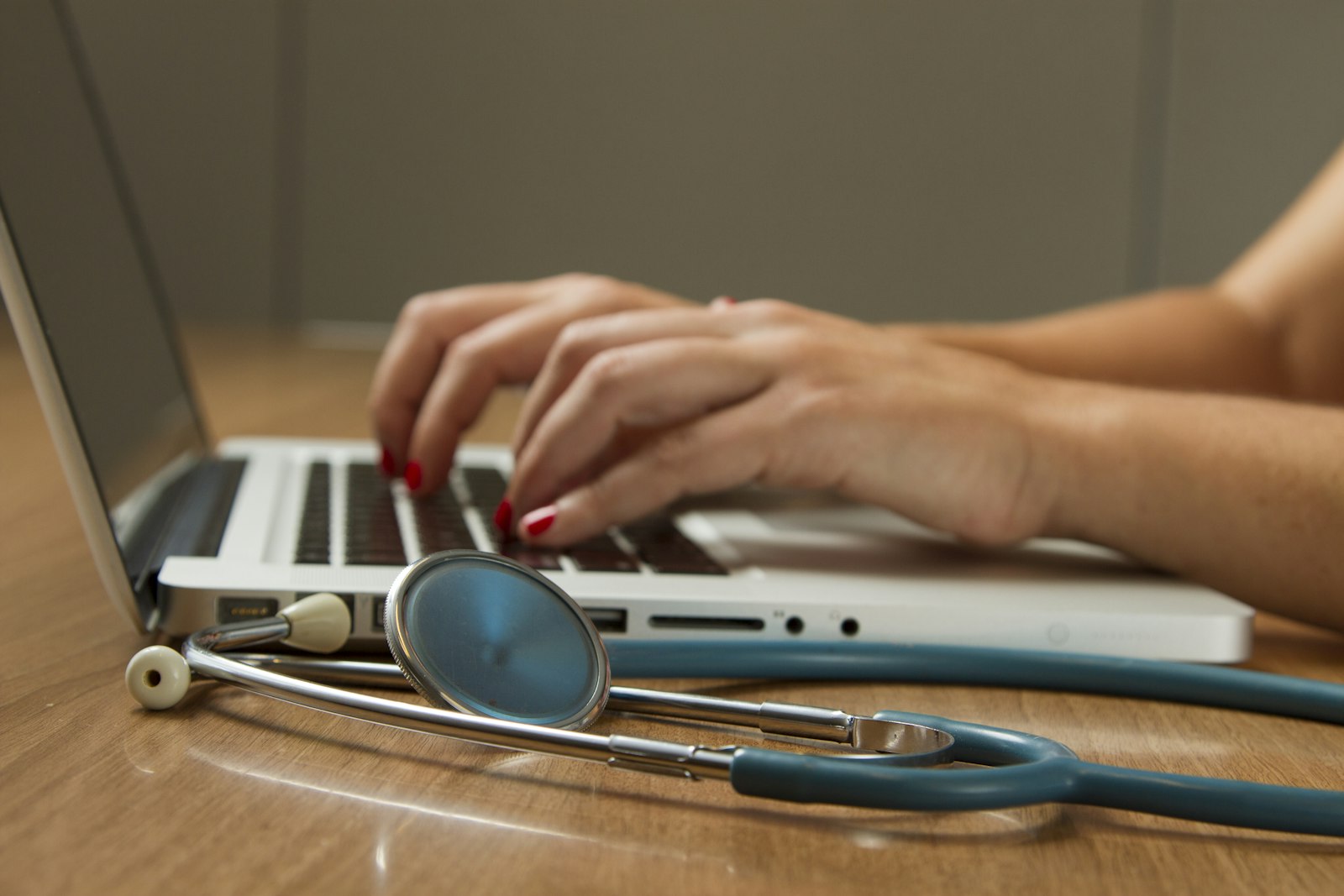 A healthcare professional reviewing records at a desk
